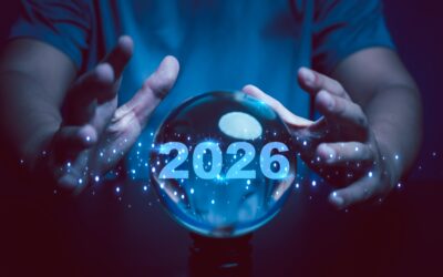 A pair of hands around a crystal ball that has the year 2026 written inside it.